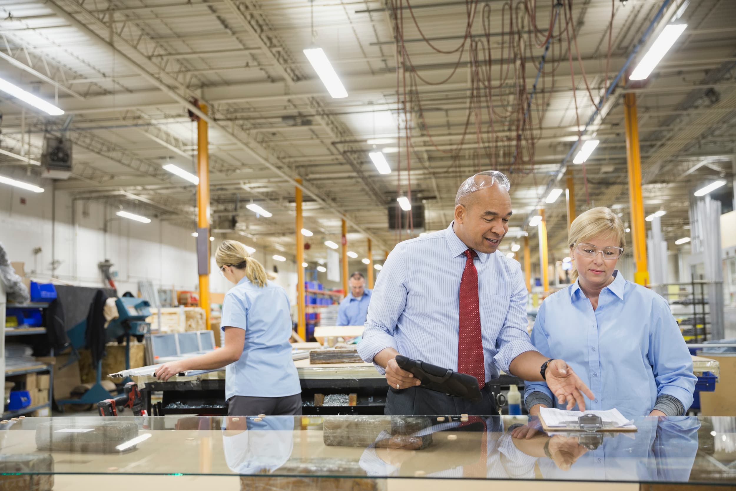 Manager and warehouse worker reviewing information